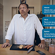 Un père qui cuisine lève les yeux au ciel parce que les membres de sa famille lui annonce tour à tour par message qu'ils ne viendront pas manger